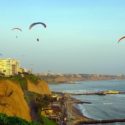 paragliding over the ocean by the seafront cliff of miraflores